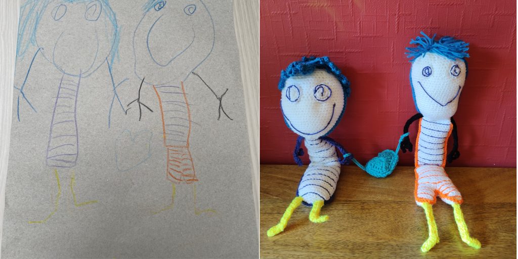 A child's stick figure drawing of Mum and Dad with their blue hair and yellow legs and blue striped and orange striped torso. On the right is are the crochet toys made from the drawing
