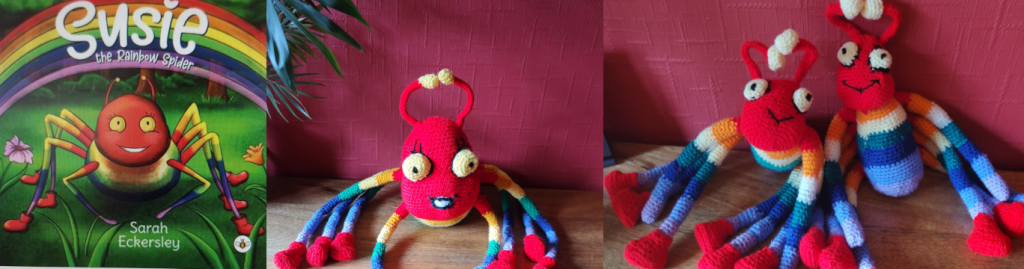 Photo showing a book of Susie the Rainbow Spider with the large crochet version right of it and two smaller crochet version to the right of that Susie has a large read face and then her body and legs go from red to orange, yellow to green to blue to purple and lilac. She is wearing read booties on six of her legs