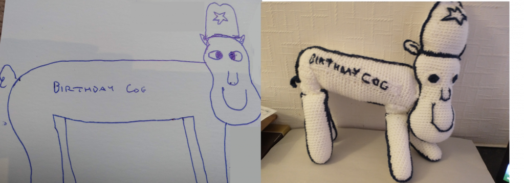 A line drawing of a cow like creature wearing what looks like an old fashioned police hat and outlined in blue. The words "Birthday Cog" are written on its torso. The crochet toy of the same is on the right