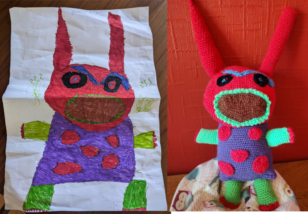 A child's drawing on the left of a scary monster with a large red head with long ears pointing upwards, a very large mouth ringed with sharp green teeth and green arms and legs with red claws on them. It has black eyes with blue pupils and a large blue monobrow which is raise over one eye. The monster has a square purple body with large red dots. On the right is the crochet version of the drawing, sitting on a little own beanbag next to a red wall.