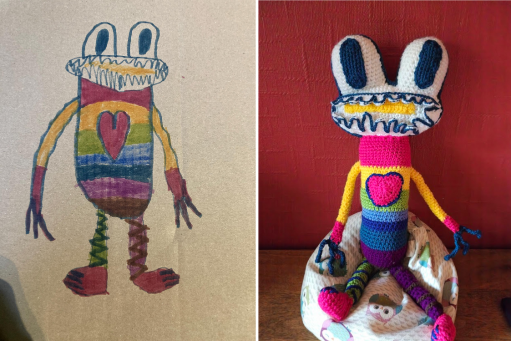 A child's drawing of a rainbow coloured frog that is standing up with it's two arms with long blue fingers handing down and it's two legs, one green with blue zig-zags, the other purple with brown zig-zags straight under it. The head is white with two large oval eyes on top with wide blue oval pupils. It's mouth shows rows of blue teeth and a yellow maw. The body, from the neck down, consists of pink, yellow green. light blue, dark blue, purple and brown stripes. The arms are yellow and the hands pink. On the right is a photo of the crochet version of the toy sitting on a little owl beanbag next to a red wall.